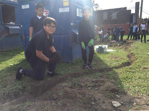students working on the trench for the rain garden 
